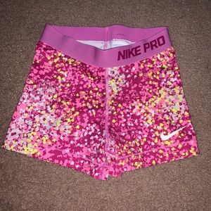 Women’s pink yellow and white nike pros